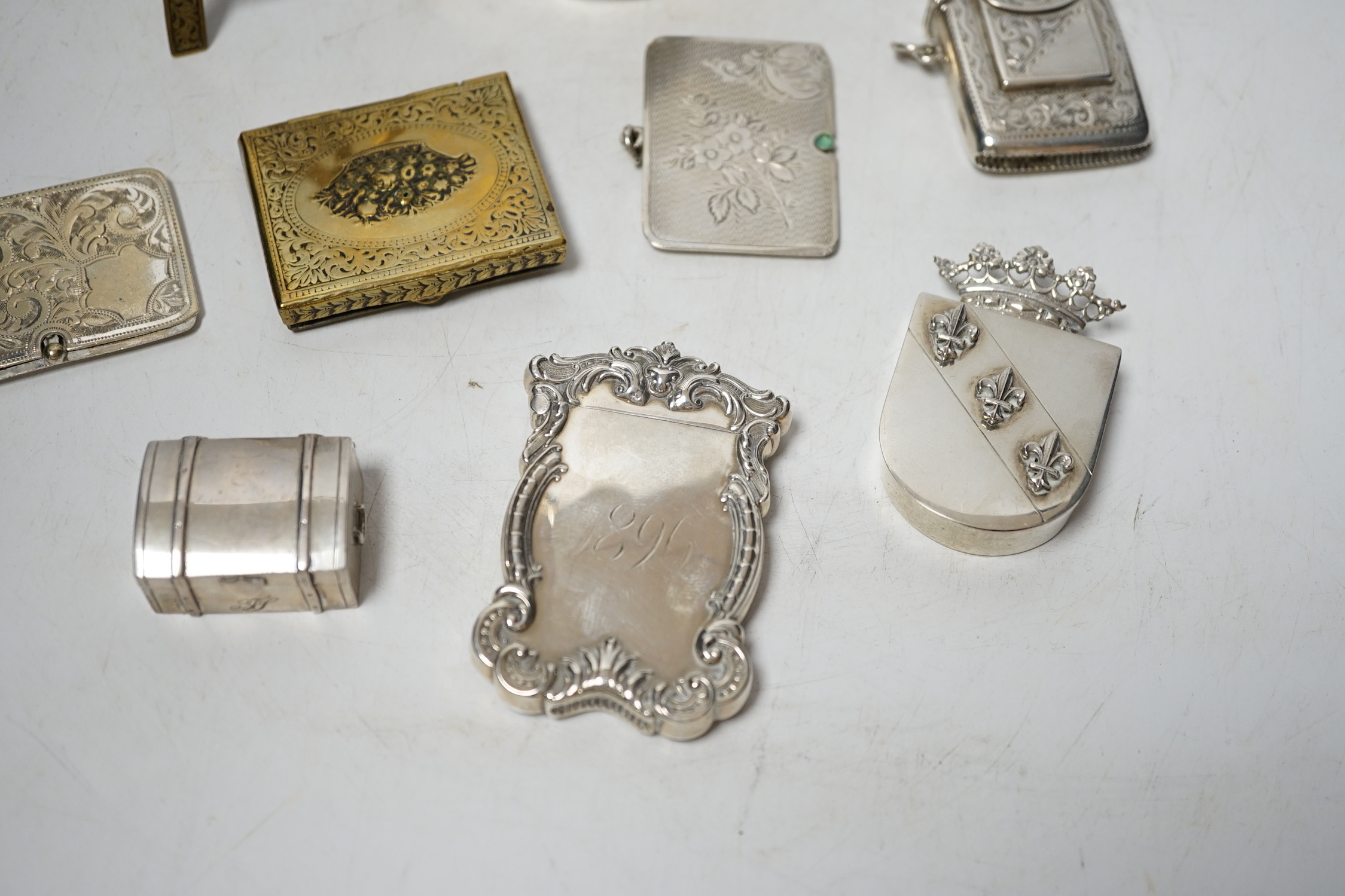 An Edwardian engraved silver combination stamp box/vesta case, Birmingham, 1906, 48mm, a similar silver slide action stamp case and seven other items including white metal box and sterling dispenser, etc.